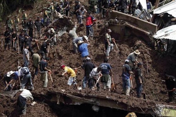 Soldiers, police officers and residents search for victims Wednesday after the landslide Santa Maria Tlahuitoltepec, Mexico.